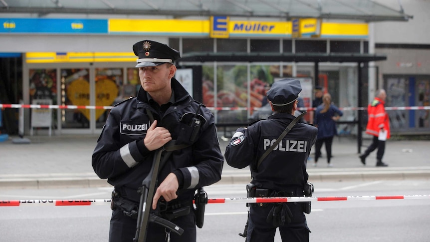 German police stand outside a supermarket in Hamburg.