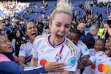 Ellie Carpenter jumps for joy with Lyon teammates after winning a Champions League game.