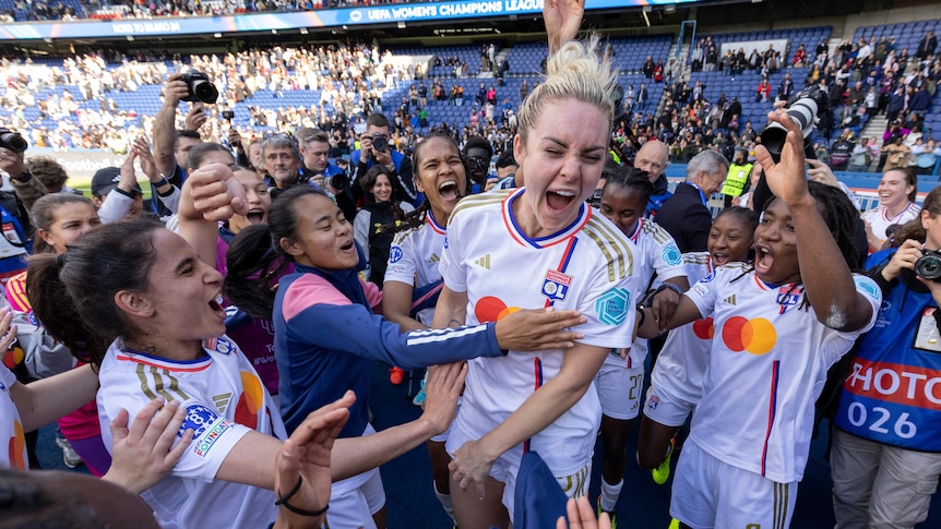 Ellie Carpenter jumps for joy with Lyon teammates after winning a Champions League game.