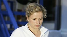 Kim Clijsters leaves a press conference after announcing her pull-out from Sydney International