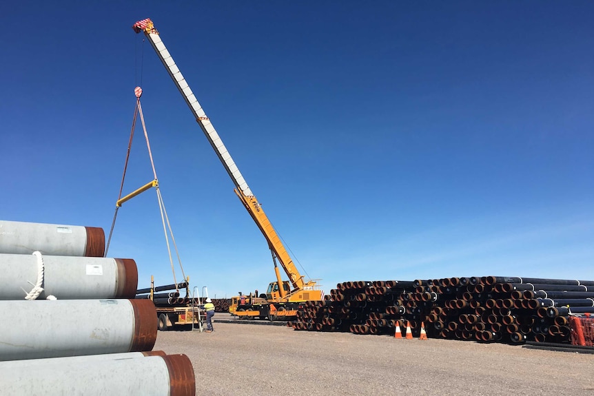 Stacked pipe in Tennant Creek ready for the construction of the Northern Gas Pipeline.