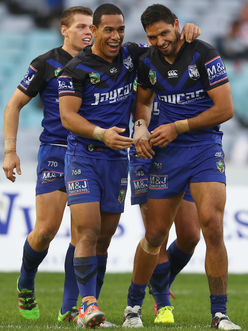 Will Hopoate and Curtis Rona celebrate a try against the Dragons