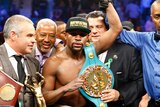 Floyd Mayweather celebrates with belt after beating Pacquiao