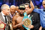 Floyd Mayweather celebrates with belt after beating Pacquiao