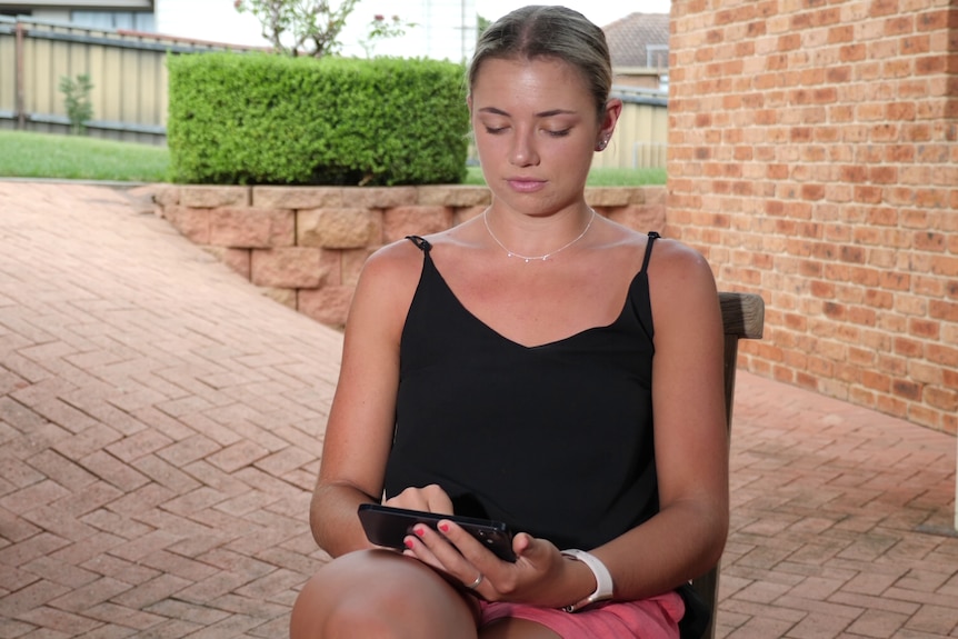 a young woman watching a video on her phone