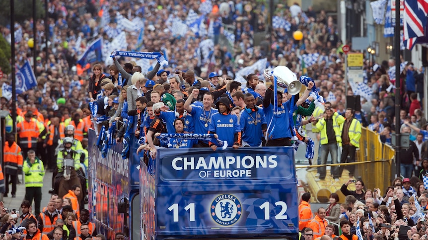 Chelsea show off the Champions League trophy to fans lining Kings Road in Chelsea.