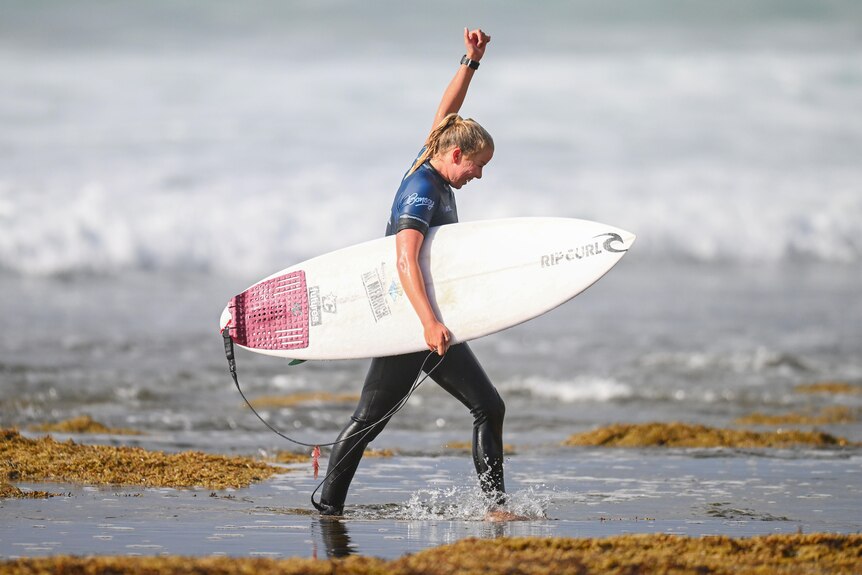 Ellie Harrison puts her fist in the air after winning a heat at Bells Beach.