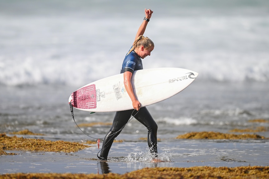 Ellie Harrison puts her fist in the air after winning a heat at Bells Beach.