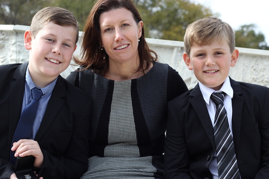 Thomas, Kellie and Henry Harrison attend the first national memorial service for emergency and fire service personnel, where their father and husband Andrew was honoured.