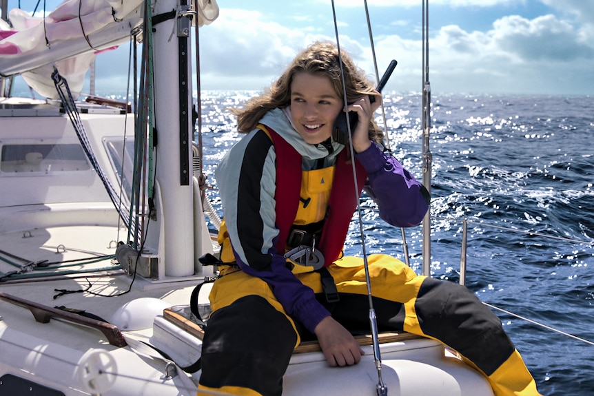 Teagan, in character as Jessica Watson, onboard her ship as she uses her walkie talkie.