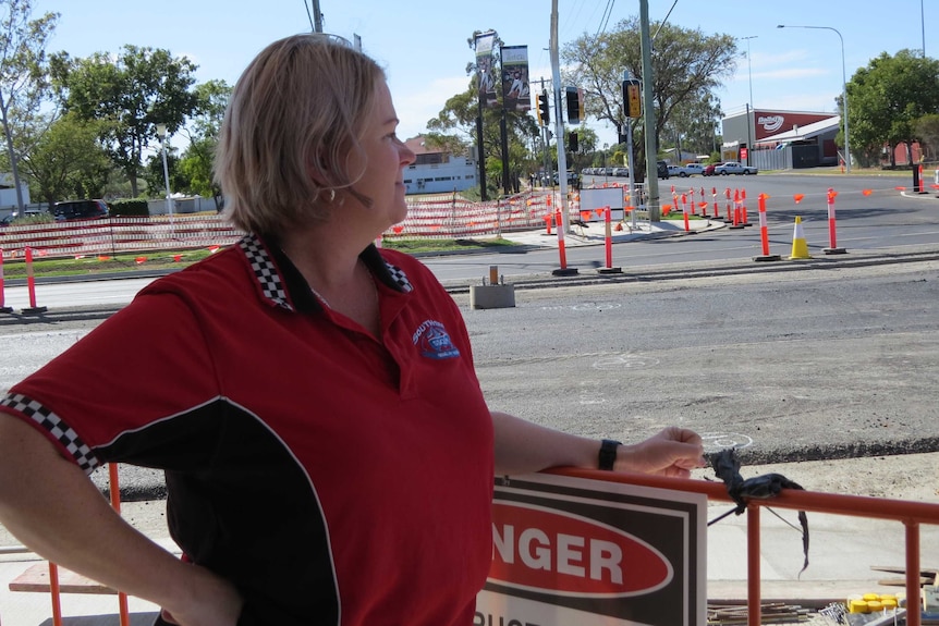 Elisha Beil stands outside her shop, looking out to the construction.