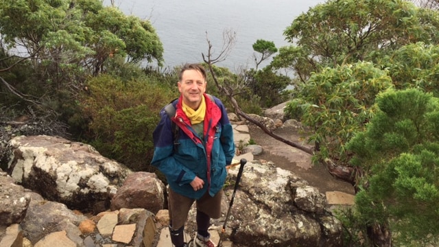 Paul Pritchard walking Cape Hauy trail in the Tasman National Park, Tasmania.