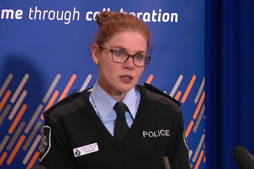 a police woman wearing glasses talking