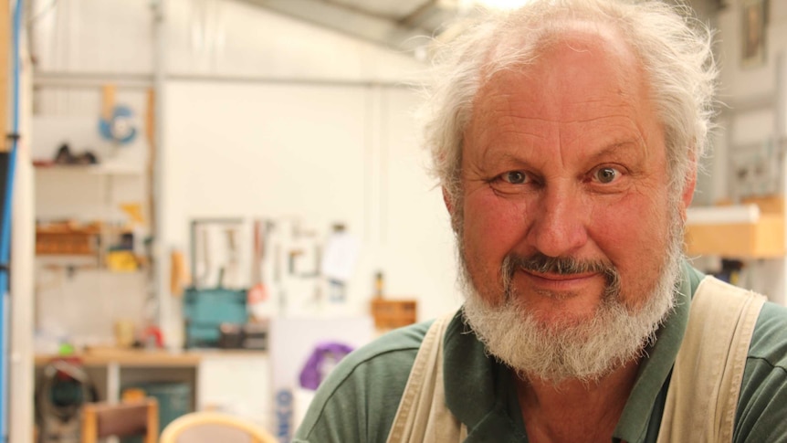 Maurice Smith sitting in his workshop near Kingston in southern Tasmania.