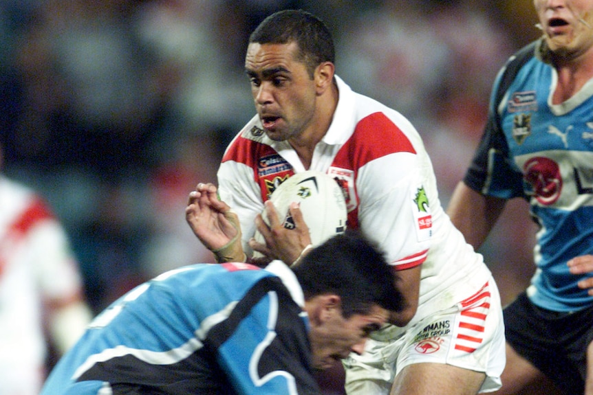 A St George Illawarra NRL player is tackled by a Cronulla opponent during the 2006 NRL season.