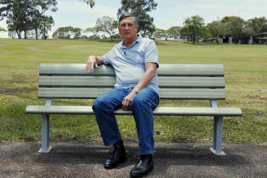 Lee Johnson sits on a park bench