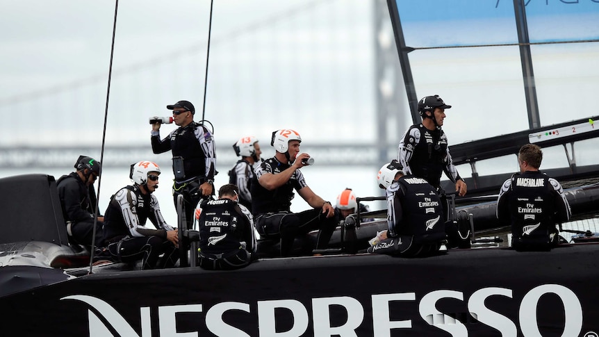 Team New Zealand sits on their boat after race 13 of the America's Cup was abandoned.