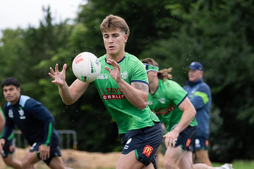 A player catches the ball during a rugby league training session