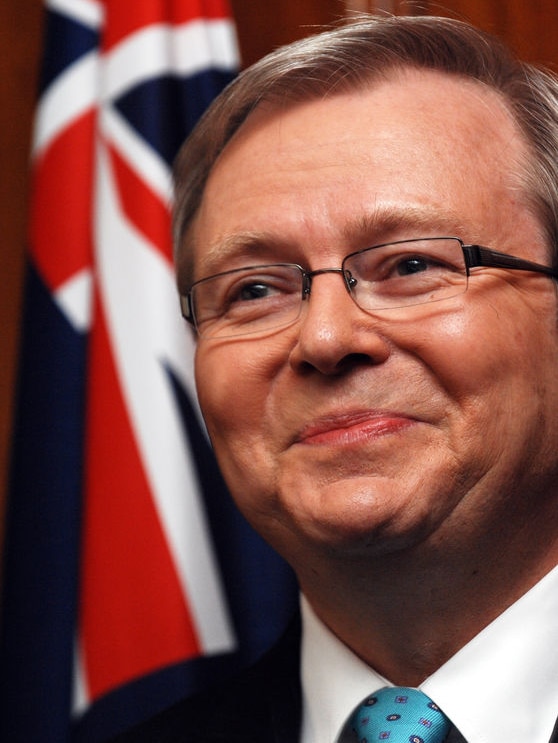 Kevin Rudd smiling with Australian flag in background