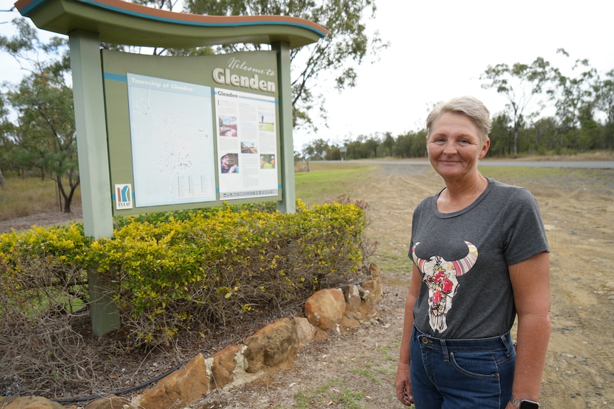 A lady in a dark coloured t-shirt standing near the Glenden town sign.