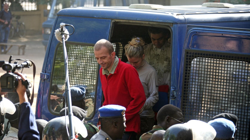 The head of the French charity Zoe's Ark, Eric Breteau (C) and charity workers Emilie Lelouche and Philippe Van Wilkelberg arrive at the courthouse, on the second day of their trial. (File photo