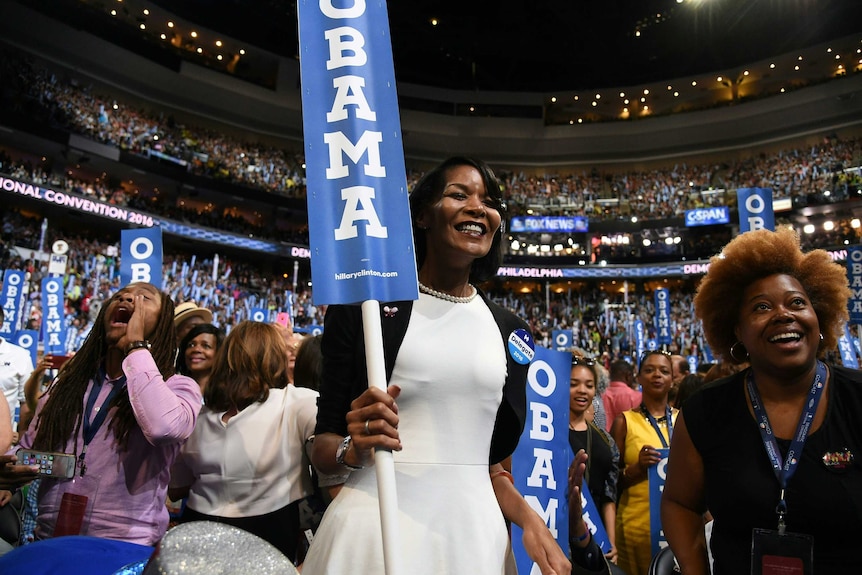 Delegates hold up signs in Democratic Convention crowd