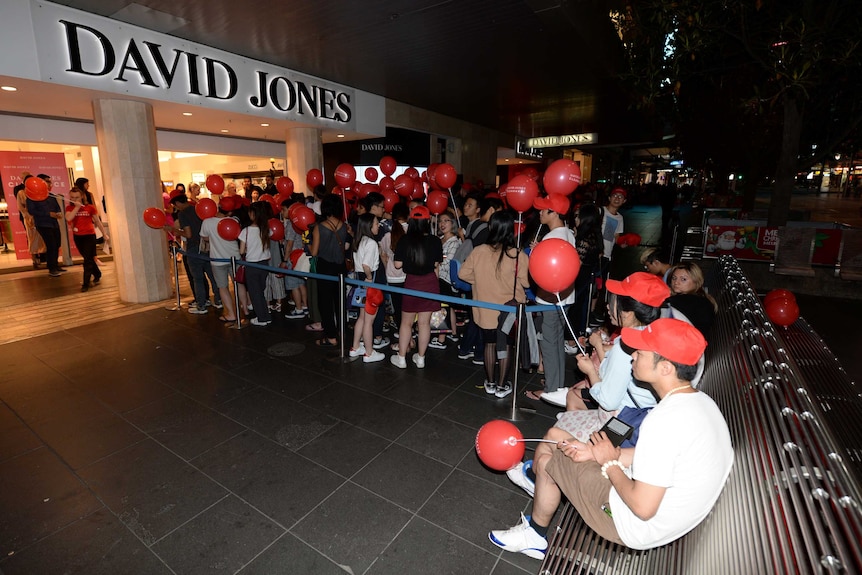 Shoppers queue in the dark on Boxing Day