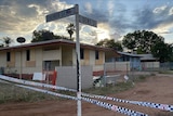 An intersection in a remote town cordoned off with police tape.
