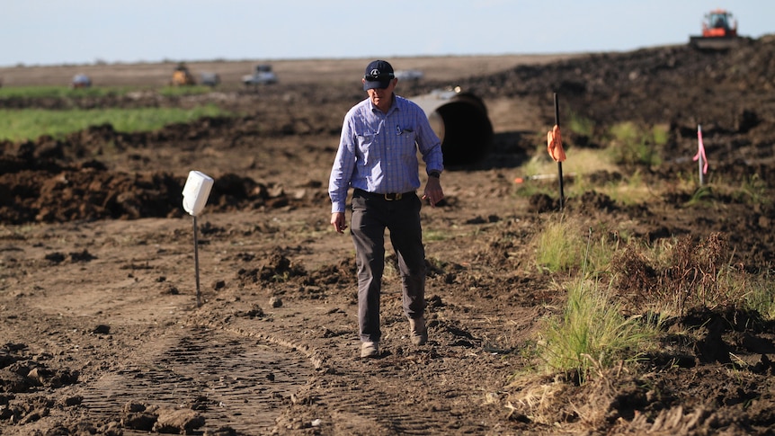 Man standing in the dirt.