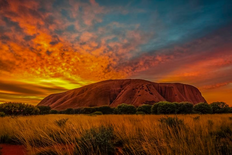 The sun sets over Uluru.