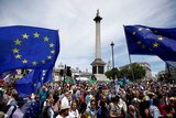 Protesters in Trafalgar Square holding European Union flags.