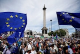 Protesters in Trafalgar Square holding European Union flags.