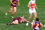 Lions defender Harris Andrews lies on the ground after a collision with Jeremy Cameron.