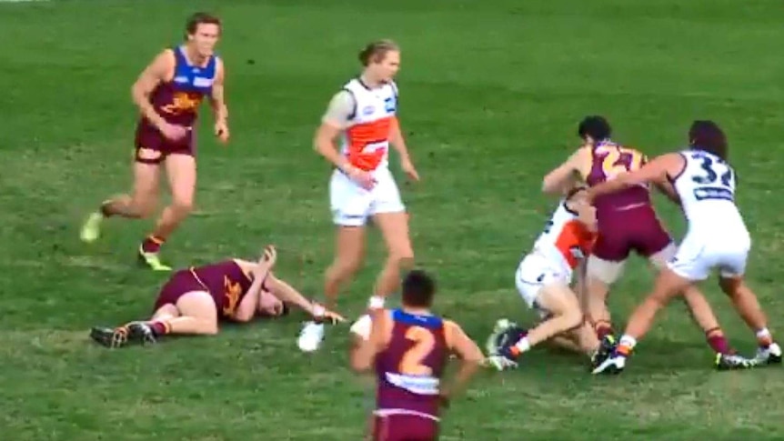 Lions defender Harris Andrews lies on the ground after a collision with Jeremy Cameron.