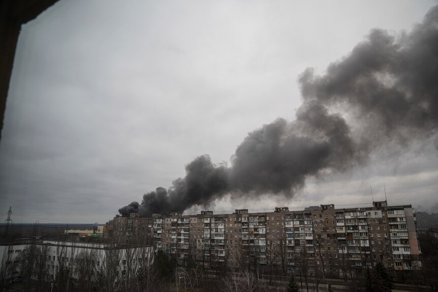 Smoke rises from buildings.