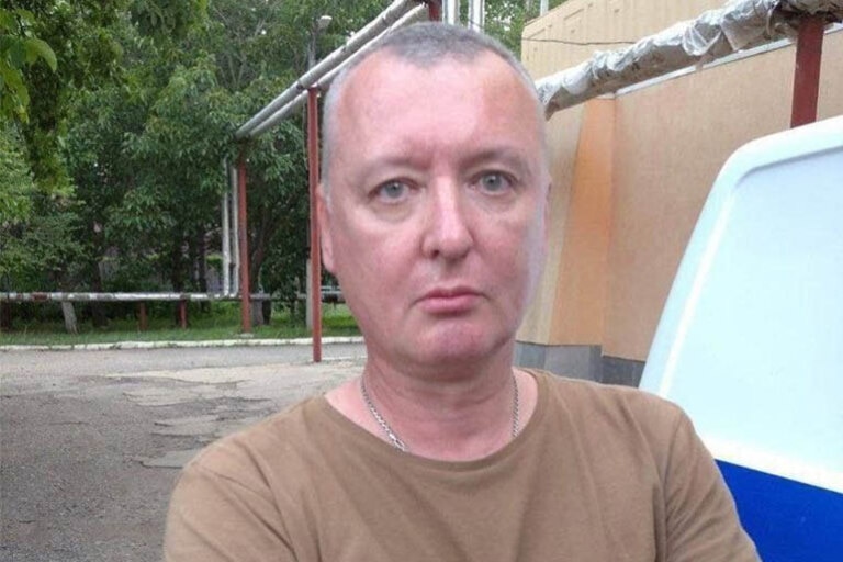 A man with close cropped hair looking solemn