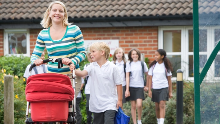 A mother and her children walking home from school.