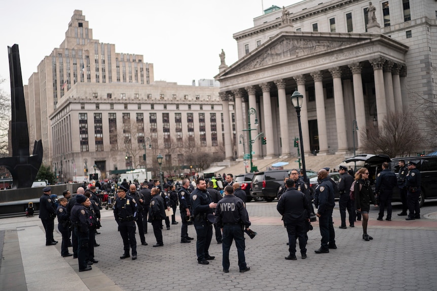 New York Police officers wait for instructions around the courthouse ahead of Trump's possible arrest.