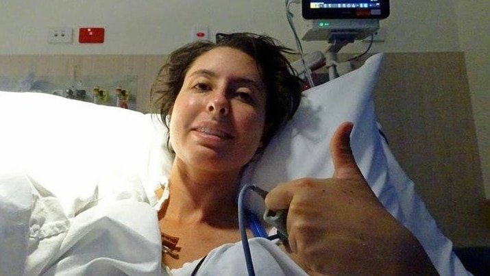 Zerena Di-Prima gives the thumbs up from a hospital bed.