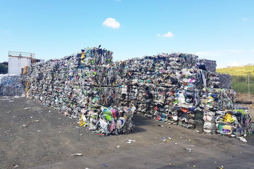 Hundreds of bales of low grade plastics sorted for recycling.