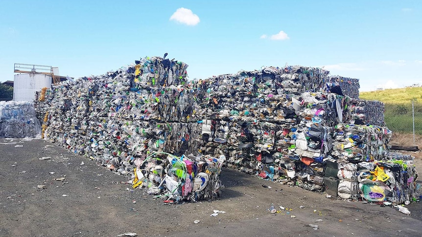 Hundreds of bales of low grade plastics sorted for recycling.