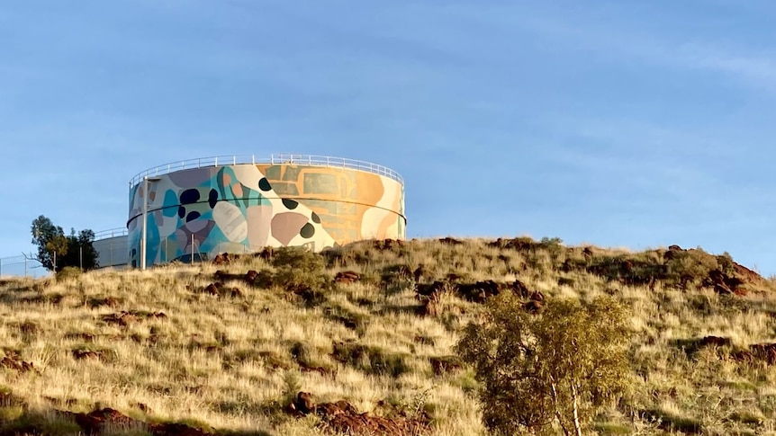 A painted water tank on a hill in Karratha.