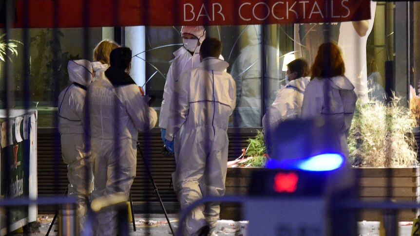 Forensic experts inspect the site of an attack outside the Stade de France stadium