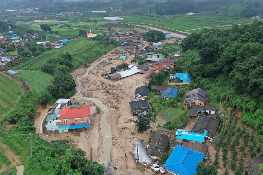 Houses collapsed from a landslide caused by heavy rain are seen in an ariel view.