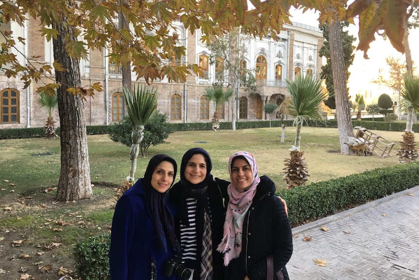 Fatemeh Javidan and sisters smiling outside Golestan Palace in Tehran