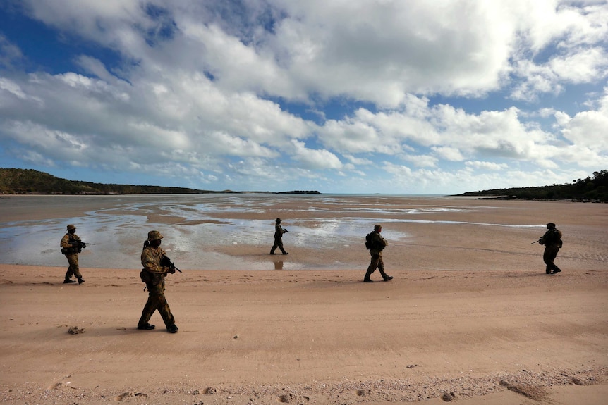 Soldiers from NORFORCE patrol a beach on Astell Island.
