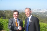 Queensland state MP Ronan Lee (l) shakes hands with Greens leader Bob Brown after announcing his def