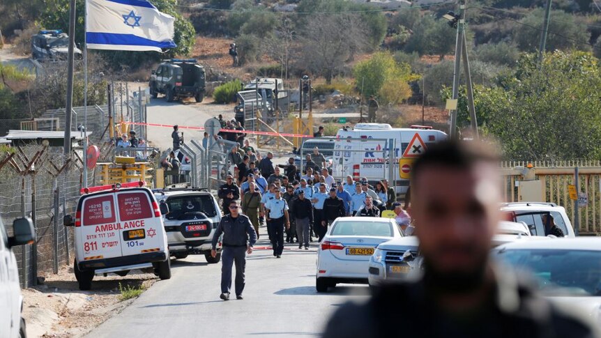 Israeli security personnel work at the scene.