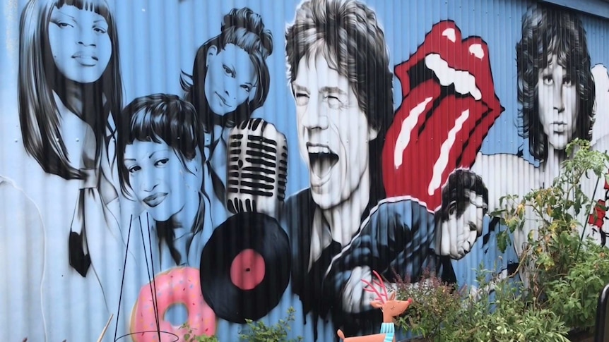 Mural of musicians including Salt and Pepa, Mick Jagger and the Doors.