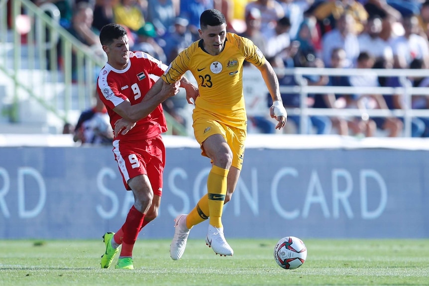 Socceroos midfielder Tom Rogic works the ball past his marker in the Asian Cup